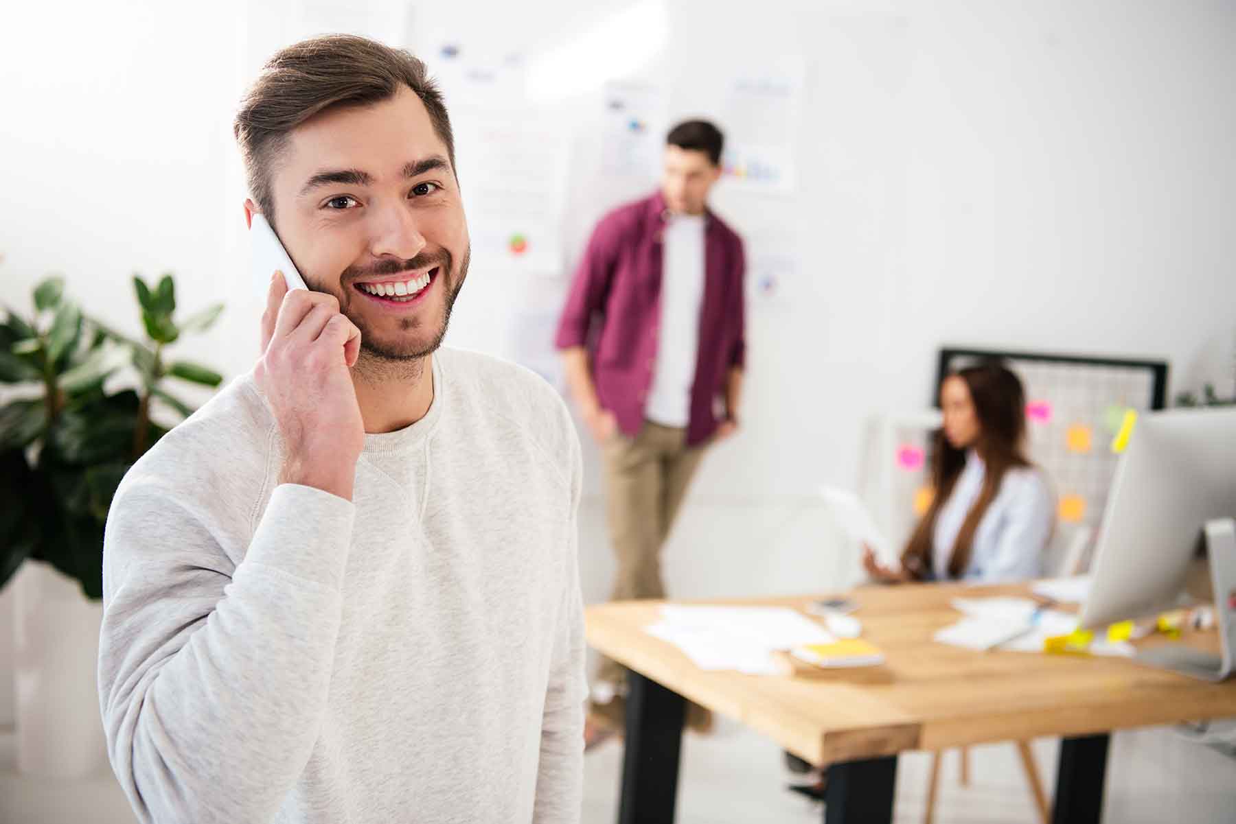 selective-focus-of-smiling-businessman-talking-on-EFB9X6C-1.jpg